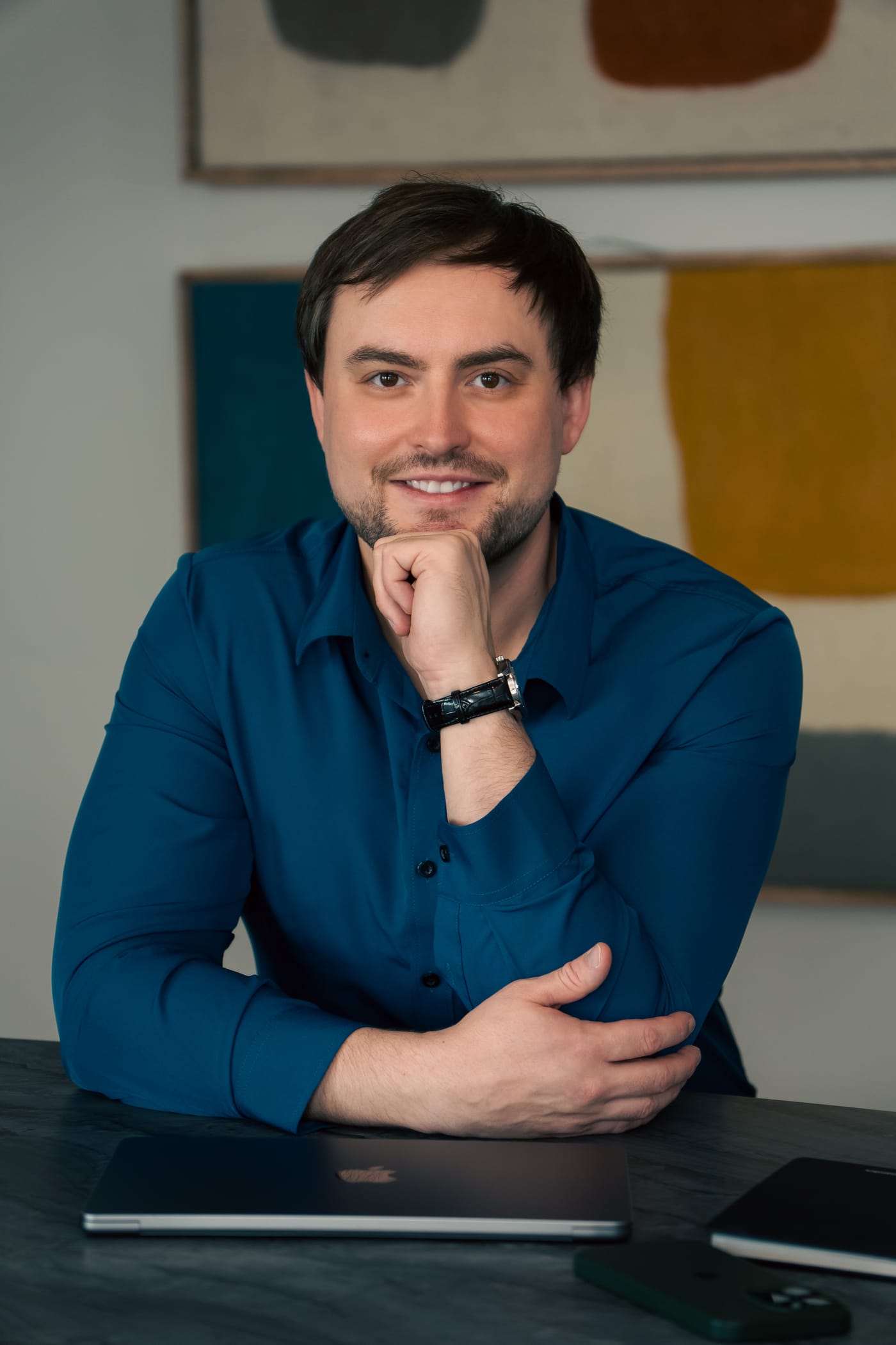 Viktor Kovalov holding a camera in a studio portrait